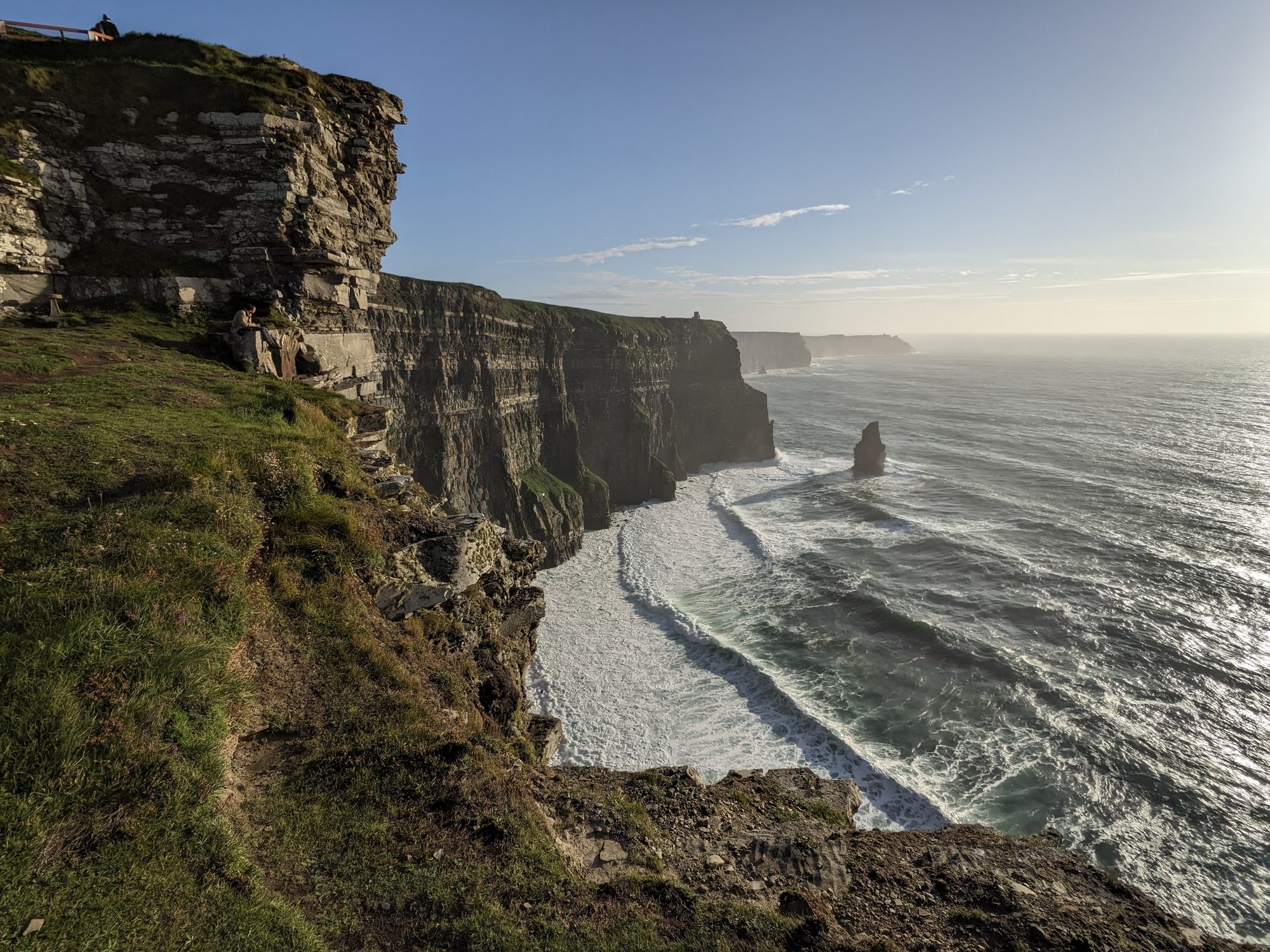 The Cliffs of Moher stretching along the coast toward the ocean